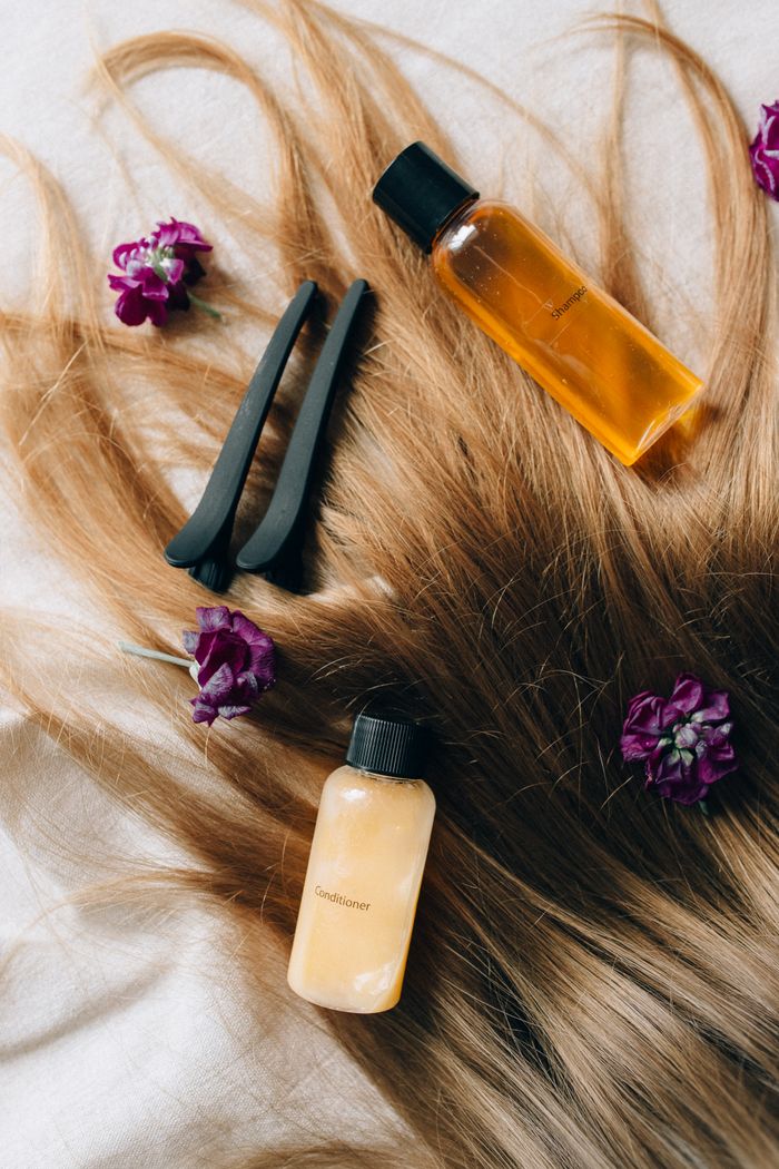 The Art of Drawing Readers In: Your attractive post title goes here Aesthetic flatlay of hair care items and flowers against a soft background.